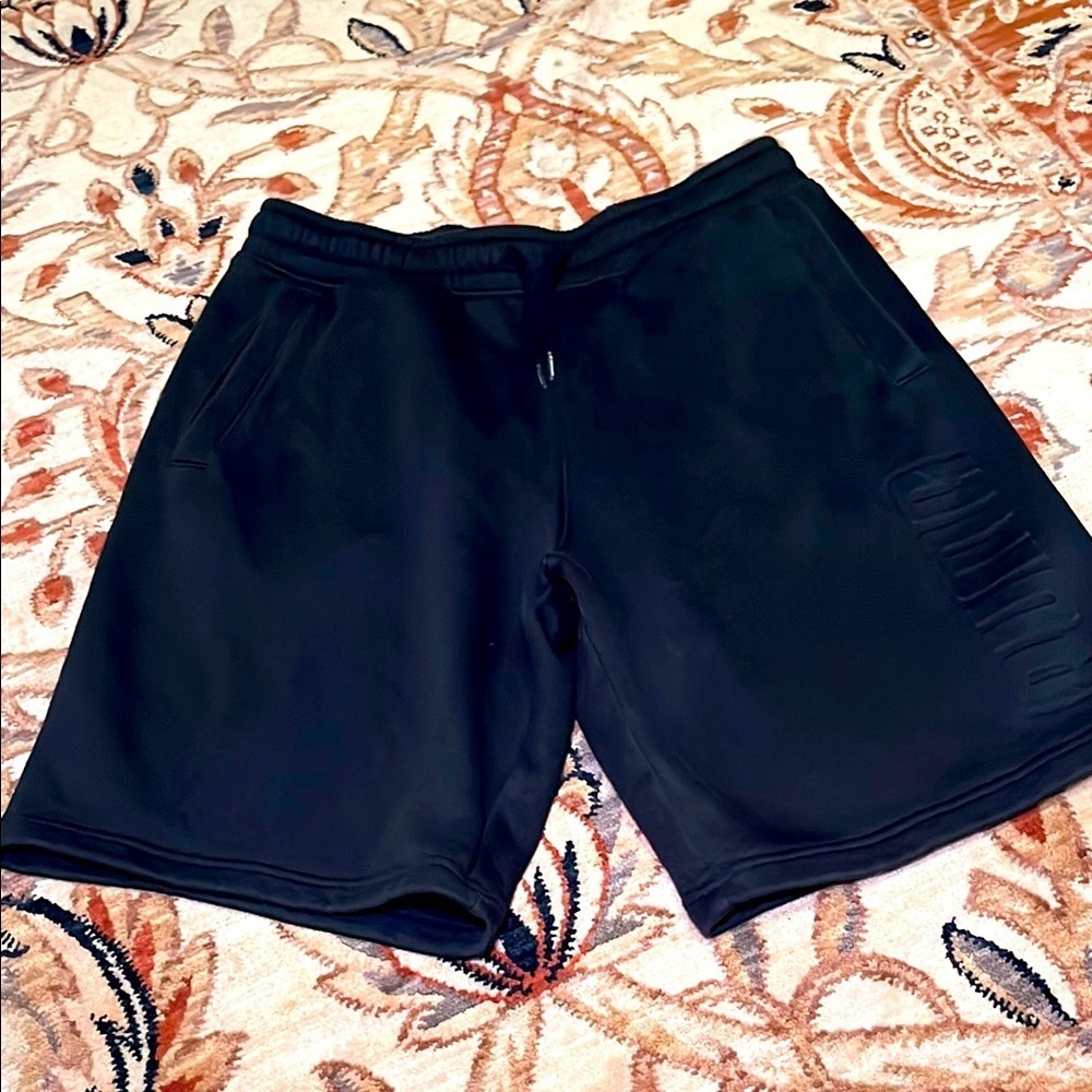 Puma black sweatpants shorts with front pockets, size medium